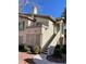 Inviting home exterior featuring a private balcony with stair access and beautiful desert landscaping at 5710 E Tropicana Ave # 2047, Las Vegas, NV 89122