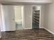 A bedroom area with wood-look flooring, and access to a bathroom with a shower/tub combo at 575 S Royal Crest Cir # 13, Las Vegas, NV 89169