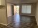 A view of the living room with wood-look flooring and a bright, outdoor view from the doorway at 575 S Royal Crest Cir # 13, Las Vegas, NV 89169