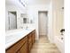 Bright bathroom with double sinks, soaking tub, and wood-look flooring at 5829 Aqua Verde St, North Las Vegas, NV 89031