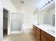 Large bathroom featuring a walk-in shower, double sink vanity and wood-look flooring at 5829 Aqua Verde St, North Las Vegas, NV 89031