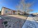 Charming single-story home with desert landscaping, a well-maintained lawn, and a two-car garage at 5829 Aqua Verde St, North Las Vegas, NV 89031