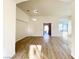 Bright living room featuring wood-look flooring and natural light from transom windows at 5829 Aqua Verde St, North Las Vegas, NV 89031