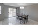 Bright dining area featuring a modern light fixture and sliding glass door access to the backyard at 6250 W Flamingo Rd # 7, Las Vegas, NV 89103