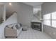 Neutral living room featuring tile floors, a cozy couch, and a fireplace with natural light from the window at 6250 W Flamingo Rd # 7, Las Vegas, NV 89103