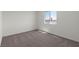 Bright, carpeted bedroom with natural light and blank walls at 6257 Blood Lily Ave, Las Vegas, NV 89122