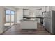 Modern kitchen with stainless steel appliances, a central island, and sliding glass doors to the backyard at 6257 Blood Lily Ave, Las Vegas, NV 89122