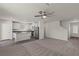 Bright, open living space with a ceiling fan, seamlessly connecting the kitchen with new appliances at 6257 Blood Lily Ave, Las Vegas, NV 89122