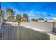 Enclosed backyard with trees visible above concrete block wall and gravel bed at 691 Anne Ln # 0, Henderson, NV 89015