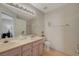 Bright bathroom with double sinks, vanity, and well-lit mirror for easy morning routines at 691 Anne Ln # 0, Henderson, NV 89015