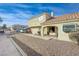 Inviting townhome exterior showcasing well-maintained landscaping, a desert rock yard, and a tile roof at 691 Anne Ln # 0, Henderson, NV 89015