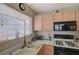 Well-lit kitchen boasts a large window over the sink for natural light and modern appliances at 691 Anne Ln # 0, Henderson, NV 89015