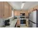 Kitchen featuring neutral countertops, stainless steel refrigerator, and modern appliances, creating an inviting cooking space at 691 Anne Ln # 0, Henderson, NV 89015