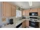 This bright kitchen has neutral countertops, modern appliances, and ample natural light for meal preparation at 691 Anne Ln # 0, Henderson, NV 89015