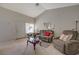 Bright living area with neutral carpet, cozy seating, and a view of the front yard at 691 Anne Ln # 0, Henderson, NV 89015