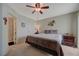 Relaxing main bedroom features soft lighting, ceiling fan, and adjacent bathroom for added privacy at 691 Anne Ln # 0, Henderson, NV 89015