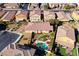 Aerial perspective of a backyard showcasing a private pool, desert landscaping, and a cozy outdoor setting at 746 Royal Course Ct, Las Vegas, NV 89148