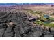 Stunning aerial view of community surrounded by a beautiful mountain range, golf course and ponds at 746 Royal Course Ct, Las Vegas, NV 89148