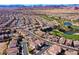 Stunning aerial view of community surrounded by a beautiful mountain range, golf course and ponds at 746 Royal Course Ct, Las Vegas, NV 89148