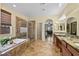 An inviting bathroom featuring a large soaking tub, step-in shower, and dual sink vanity at 746 Royal Course Ct, Las Vegas, NV 89148