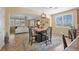 Dining area opens up to the living room; features a stylish dining table set and lots of natural light at 746 Royal Course Ct, Las Vegas, NV 89148