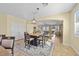 Dining area opens up to the living room; features a stylish dining table set and lots of natural light at 746 Royal Course Ct, Las Vegas, NV 89148