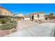 Charming single-story home featuring a desert landscape, paved driveway, and a two-car garage at 746 Royal Course Ct, Las Vegas, NV 89148