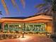 Exterior view of a fitness center featuring large glass windows showcasing state-of-the-art gym equipment and palm trees at 746 Royal Course Ct, Las Vegas, NV 89148