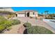 Charming single-story home featuring a desert landscape, paved driveway, and a two-car garage at 746 Royal Course Ct, Las Vegas, NV 89148