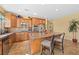 Kitchen features stainless appliances, wood cabinets, granite countertops, tile backsplash and barstool seating at 746 Royal Course Ct, Las Vegas, NV 89148