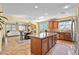 Kitchen island with granite countertops and seating, opens up to the dining area and living room at 746 Royal Course Ct, Las Vegas, NV 89148