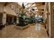 Bright lobby with high ceilings, skylights, pendant lights, and tropical plants at 746 Royal Course Ct, Las Vegas, NV 89148