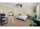 Serene main bedroom featuring a ceiling fan, plants and tiled floors at 746 Royal Course Ct, Las Vegas, NV 89148