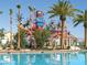 Community swimming pool with a splash park featuring slides, a water bucket, and shaded seating areas at 746 Royal Course Ct, Las Vegas, NV 89148