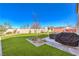 Expansive backyard with a lush lawn and a barbecue area at 7848 Desert Bell Ave, Las Vegas, NV 89128