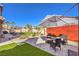 Inviting backyard with lush turf, patio, and shade umbrellas at 7848 Desert Bell Ave, Las Vegas, NV 89128