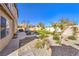 Beautiful backyard with gravel accented by turf and desert landscaping at 7848 Desert Bell Ave, Las Vegas, NV 89128