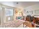 Bright bedroom featuring a window with blinds, a rug, and functional furniture for storage at 7848 Desert Bell Ave, Las Vegas, NV 89128