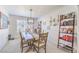 Dining area with a wooden table, stylish chairs, and modern light fixture at 7848 Desert Bell Ave, Las Vegas, NV 89128