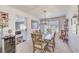 Dining area with an adjacent wine fridge and a view into the bright white kitchen at 7848 Desert Bell Ave, Las Vegas, NV 89128