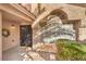 Close-up of the front entrance featuring a secure gate, decorative wreath, and stylish window at 7848 Desert Bell Ave, Las Vegas, NV 89128