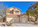 Well-maintained two-story home featuring a three-car garage and desert landscaping at 7848 Desert Bell Ave, Las Vegas, NV 89128