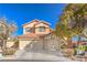 Charming two-story home with a well-manicured front yard and a spacious three-car garage at 7848 Desert Bell Ave, Las Vegas, NV 89128