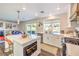 Bright kitchen featuring a large window, modern appliances, and an island with bar stools at 7848 Desert Bell Ave, Las Vegas, NV 89128