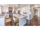 Modern white kitchen featuring an island with seating and stainless steel appliances at 7848 Desert Bell Ave, Las Vegas, NV 89128