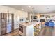 Modern kitchen featuring stainless steel appliances, a kitchen island with an oven, and bar stools at 7848 Desert Bell Ave, Las Vegas, NV 89128