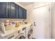 Functional laundry room equipped with a washer, a dryer, and storage cabinets at 7848 Desert Bell Ave, Las Vegas, NV 89128