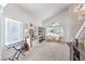 Bright and airy living room featuring large windows and a vaulted ceiling at 7848 Desert Bell Ave, Las Vegas, NV 89128