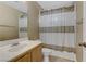 Neutral bathroom featuring a vanity with a white sink and a shower/tub combo with a decorative curtain at 8235 Misty Sage St, Las Vegas, NV 89139