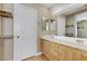 Bathroom featuring a double sink vanity with wood cabinets and a large mirror at 8235 Misty Sage St, Las Vegas, NV 89139